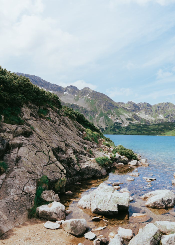 A lake surrounded by rocks and grass